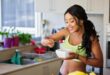 woman eating strawberry in the kitchen