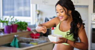 woman eating strawberry in the kitchen