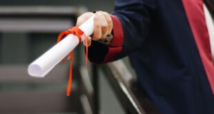 person holding white scroll