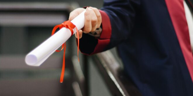 person holding white scroll