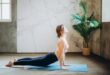 woman in pink sports bra and black leggings doing yoga on yoga mat
