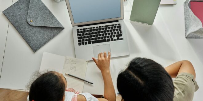 mother helping her daughter with her homework