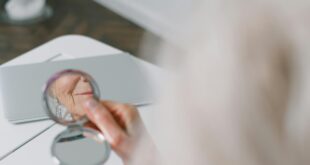 person holding a round mirror