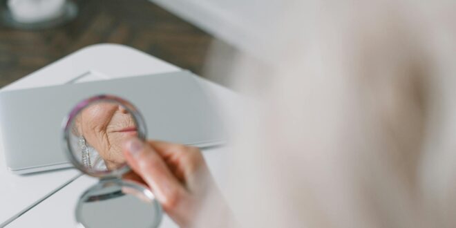 person holding a round mirror
